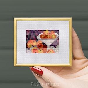 May include: A cross-stitch pattern of a bowl of fruit, with oranges and peaches in a white bowl on a purple background.