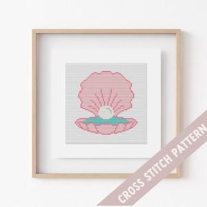 May include: Cross stitch pattern featuring a pink seashell with a white pearl inside. The seashell is on a teal background.