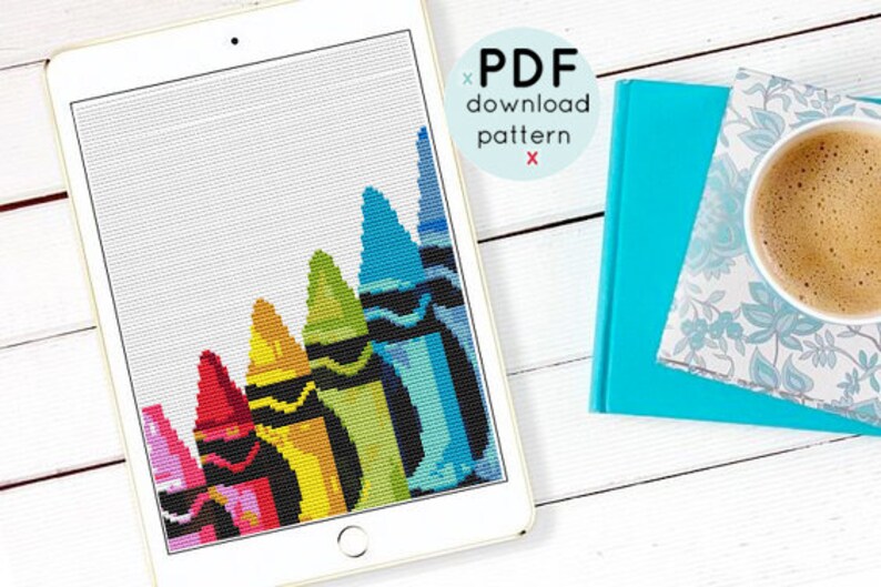 May include: A digital download pattern for a cross stitch design featuring a row of colorful crayons. The crayons are arranged in a diagonal line, with the red crayon at the bottom and the blue crayon at the top. The pattern is displayed on a tablet screen.