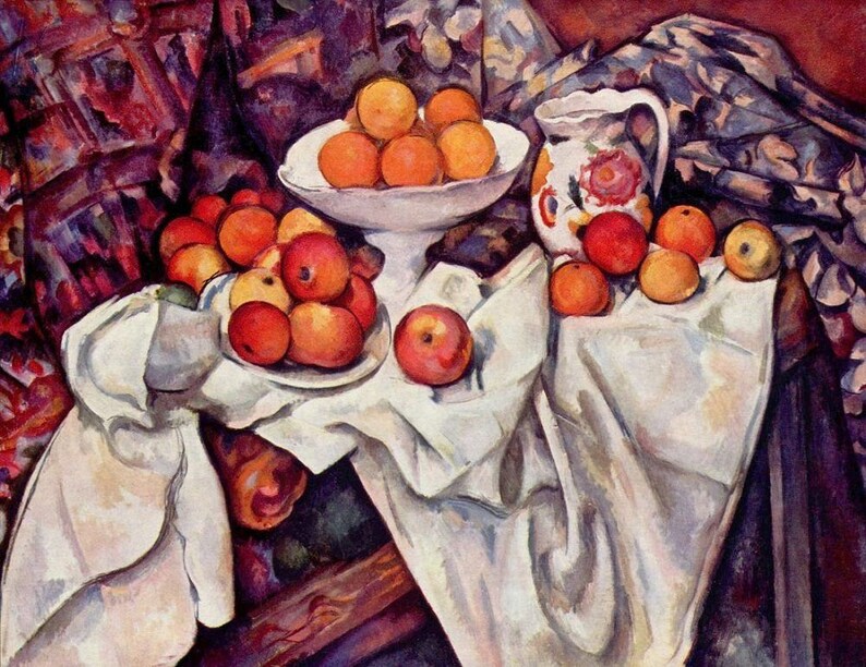 May include: A still life painting featuring a white tablecloth with a bowl of oranges and a pitcher with floral designs. The bowl and pitcher are on a wooden table with a red and blue patterned cloth in the background. There are also apples on the table.