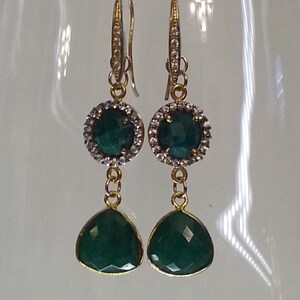 Faceted pave set round and trillion emerald earrings with 24 K gold plate hooks and bezels.