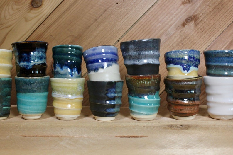 Stack of ceramic shot glasses in multiple colors