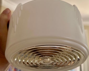 May include: White frosted glass ceiling light fixture with a decorative, concentric circle pattern on the bottom.