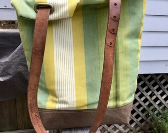 Leather strap striped tote bag in shades of green, gold, cream and brown with interior zippered pocket