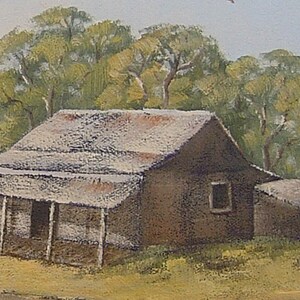May include: A rustic, weathered wooden cabin with a corrugated metal roof, surrounded by trees. The cabin has a porch with wooden posts and a single window.