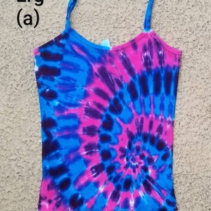 May include: A tie-dye tank top with a blue, pink, and purple swirl pattern. The tank top has a scalloped hem and is labeled "Lrg (a)".