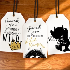 May include: Three white gift tags with black text and a black silhouette of a monster. The first tag says "thank you for making my birthday a WILD ONE". The second tag says "thank you for joining my Wild Rumpus". The third tag says "thank you".