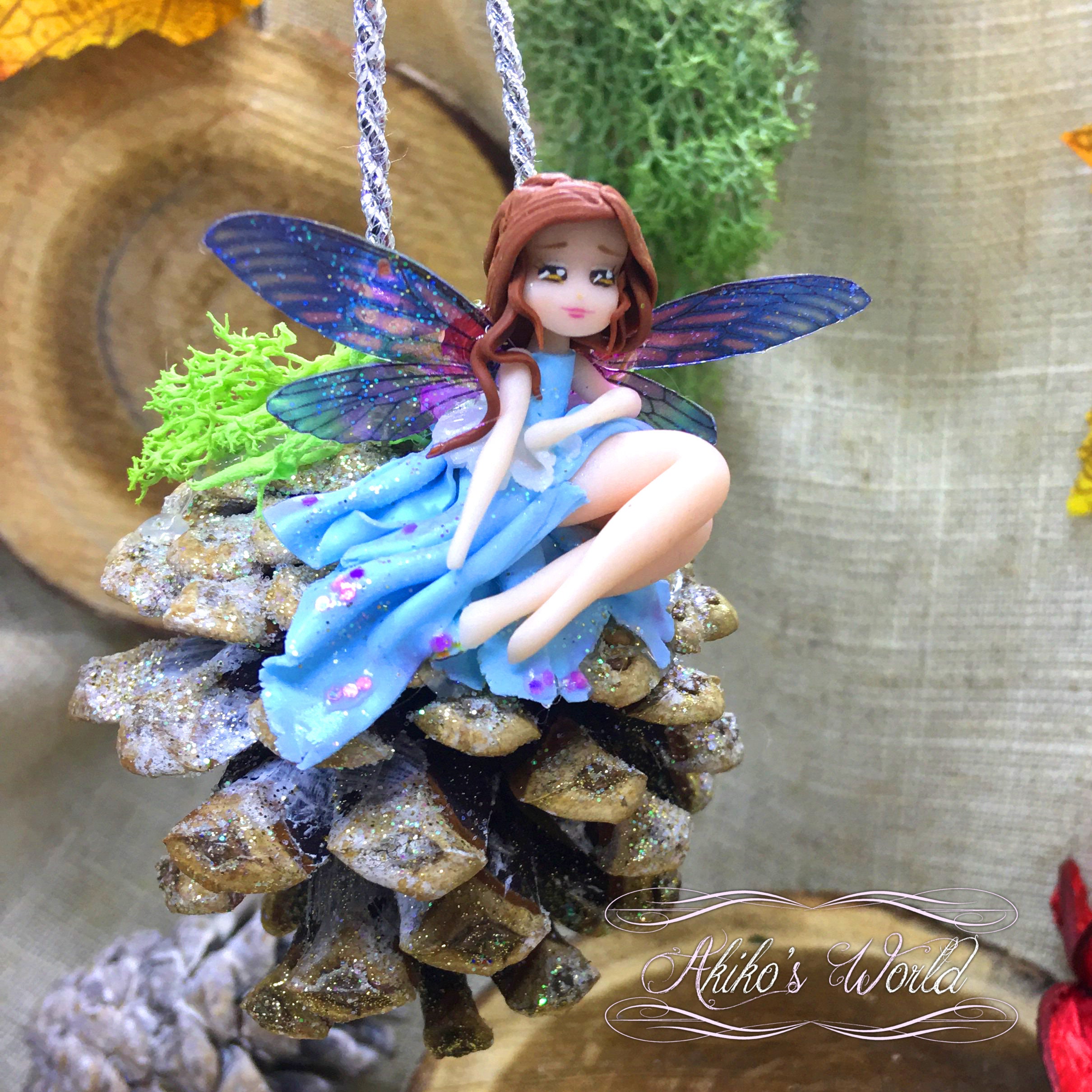 Petite Suspension Fée Bleue sur Sa Pomme de Pin - Pièce Unique Chibi en Pâte Polymère Décoration Sap