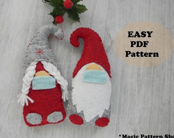 May include: Two felt gnomes wearing face masks, one with a red hat and the other with a grey hat. The gnomes are on a white wooden background with a sprig of holly above them. The text "EASY PDF Pattern" is in a circle on the right side of the image. The text "*Magic Pattern Shop*" is at the bottom of the image.