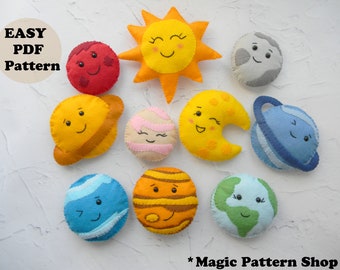 May include: A collection of felt planet and celestial body ornaments, including a smiling sun, moon, and various planets. The ornaments are in bright colors with embroidered details. Text on the image reads "EASY PDF PATTERN" and "Magic Pattern Shop".