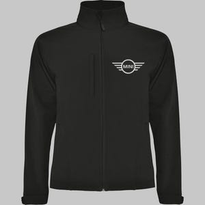 May include: Black zip-up jacket with a high collar and a white MINI logo on the chest. The jacket features a vertical pocket on the left side and a full-length zip. The jacket is made of a smooth, matte material.