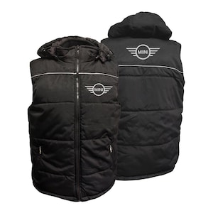 May include: Black puffer vest with a hood and a white stripe across the chest. The vest features the "MINI" logo in white on the chest and back. The vest has a full zipper and two side pockets.