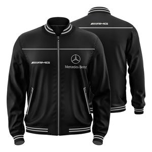 May include: Black bomber jacket with white stripes and detailing. The jacket displays the "AMG" and "Mercedes-Benz" logos. It has a zip-up front and ribbed cuffs and hem. The back of the jacket also features the "AMG" logo.