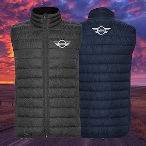 May include: Two quilted vests, one charcoal gray and one navy blue, are displayed. Each vest features a full-length zipper and the "MINI" logo in white on the chest and back. The vests are sleeveless with a high collar.