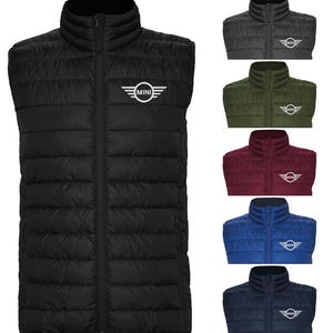 May include: Black quilted puffer vest with a full-length zipper and a stand-up collar. The vest features the "MINI" logo in white on the chest. Additional vests in charcoal, olive green, burgundy, blue, and navy blue are also shown.