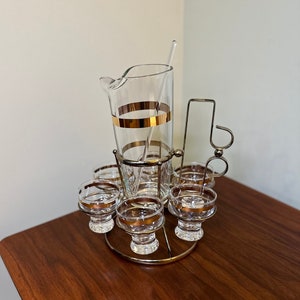 9 piece vintage gold band cocktail set with caddy.