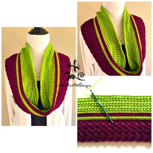 May include: A crocheted infinity scarf with a green and burgundy color scheme. The scarf is made with a lacy stitch pattern and has a solid stripe of each color.