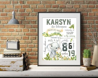 May include: A framed nursery print featuring the name "Karsyn" in green and white, with details including birth date, time, and measurements. The print includes a watercolor illustration of an elephant and measures 19 inches in height.