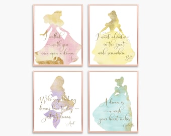 May include: Four watercolor princess silhouette prints with gold glitter accents. Each print features a different princess with a quote from the movie. The prints are framed in a rose gold frame. The quotes are: "I walked with you once upon a dream" - Aurora, "I want adventure in the great wide somewhere" - Belle, "Who says that my dreams have to stay just my dreams" - Ariel, "A dream is a wish your heart makes" - Cinderella.