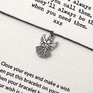 May include: A black string bracelet with a silver angel charm. The bracelet comes with a card that reads "Close your eyes and make a wish then put this bracelet on your wrist. When your bracelet breaks, your wish is coming true. They'll always be there when you need them. XXX"