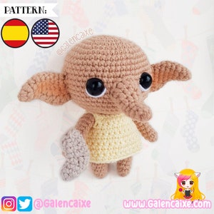 May include: Crocheted Dobby the house-elf doll wearing a yellow dress. The doll has large brown eyes and pointed ears. The doll is holding a grey crocheted sock. The image includes the text "@GalenCaixa" and "www.GalenCaixa.com".