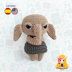 May include: Crocheted amigurumi doll of Dobby the house-elf from the Harry Potter series. The doll is brown with a grey skirt and has a grumpy expression. The doll is standing on a white background with a pattern of books, glasses, and hearts.