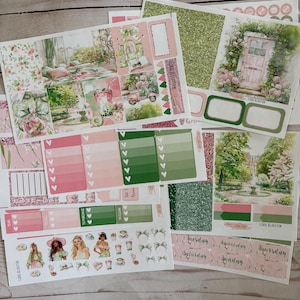 May include: A set of planner stickers featuring a floral theme with pink and green colors. The stickers include a variety of designs, such as flowers, leaves, a house, and a door. The stickers are perfect for adding a touch of whimsy to your planner.