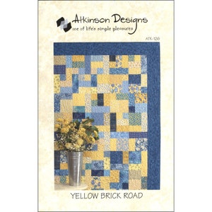 May include: Quilt pattern for a yellow and blue quilt called "Yellow Brick Road". The quilt is made up of squares of different sizes and colors. The pattern is from Atkinson Designs.