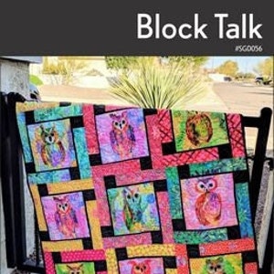 May include: A colorful quilt pattern featuring a block design with owls. The quilt is made with 10-inch squares and features a variety of colors, including pink, green, yellow, and black. The quilt is titled "Block Talk" and is designed by Swirly Girls.