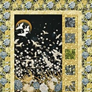 May include: A quilt block with a black background featuring white cranes flying in a night sky with a full moon. The block is surrounded by a border of yellow and white flowers.