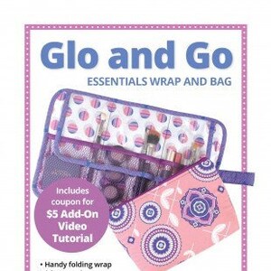 May include: A purple and pink patterned fabric wrap and bag set with a zipper closure. The set includes a coupon for a $5 add-on video tutorial. The text "Glo and Go Essentials Wrap and Bag" is at the top of the image. The text "Carry your essentials wherever you roam!" is at the bottom of the image.