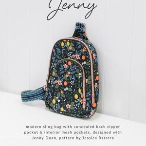 May include: A navy blue sling bag with a floral pattern of lemons, oranges, and flowers. The bag has a pink zipper and a patterned strap. The text "Jenny" is above the bag, and the text "Sallie Tomato" is below.