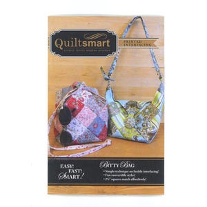 May include: A product image featuring two quilted fabric bags. The bags are in different styles, one a drawstring bag and the other a shoulder bag. The image also includes text that reads "Quiltsmart" and "Bitty Bag".