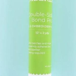 May include: A white roll of double-sided adhesive bonding fabric for crafts and embroidery. The label is green and says "Double-Sided Bond Pre", "For Embroidery", "12" x 2 yds", and "Permanently adheres two fabrics together, no sewing required".