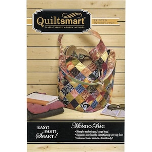 May include: A patchwork Mondo Bag with a variety of colourful fabric squares. The bag has a zip closure and a handle. The image also shows a stack of folded clothes, a pair of sunglasses, and a book. The bag is designed for quilting projects.