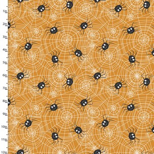 May include: A repeating pattern of black spiders with smiling faces and white spiderwebs on an orange background. The spiders are evenly spaced and the webs are detailed.