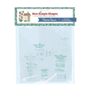 May include: A package of 63 plastic sewing templates for quilting. The templates are labeled "Sew Simple Shapes" and feature a variety of shapes, including circles, squares, and triangles. The package is blue and green with a house and strawberries on the front.