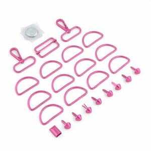 May include: A set of pink metal hardware for crafting projects. The set includes D-rings, a buckle, a swivel hook, and a variety of rivets.
