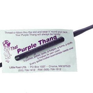 May include: A purple plastic tool called "That Purple Thang" with a slot for a ribbon. The tool is used for quilting and crafting. The text on the card reads: "Thread a ribbon thru the slot and wear it round your neck... Your Purple Thang will always be handy. That Purple Thang It pushes, pokes, pulls, p-fudges, p-tums, p-stuffs It makes its own uses! Every quilter/crafter/seamstress needs one! Little Foot LTD. PO Box 1027 Chama, NM 87520 (505) 756-1412 FAX (505) 756-1512"