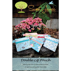 May include: A collection of double zip pouches in various floral and bird patterns. The pouches have teal zippers and are displayed on a rock surface. The image includes the text "Sweet Jane's Quilting & Design" and "Double Zip Pouch."