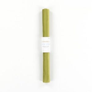 May include: A roll of olive green wrapping paper with a white label. The label has text in blue and black. The paper is rolled up vertically against a white background.