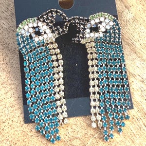 Sparkly rhinestone parrot earrings.