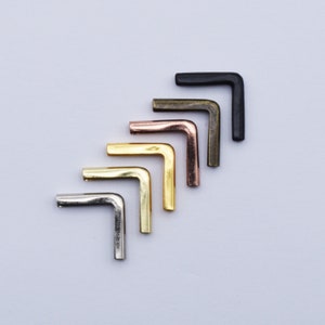 May include: Five metal corner protectors in different finishes: silver, gold, brass, copper and black. These corner protectors are ideal for protecting furniture from damage.