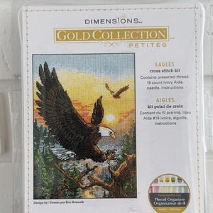 May include: A Dimensions Gold Collection Petite cross stitch kit featuring an eagle in flight. The kit includes pre-sorted thread, 18-count ivory Aida, a needle, and instructions. The finished size is 5 x 7 inches (12.7 cm x 17.7 cm).