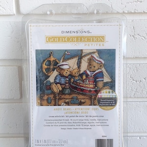 May include: Ahoy! Bears cross stitch kit from the Gold Collection Petite line. The kit includes 18 count beige Aida fabric, presorted thread, a needle, and instructions. The finished size is 7 inches by 5 inches (17.7 cm x 12.7 cm).