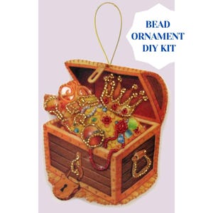May include: A wooden treasure chest ornament kit with a gold crown and jewels inside. The kit includes beads and instructions for creating a beaded ornament. Bead Ornament DIY Kit.