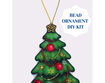 May include: A green Christmas tree-shaped bead ornament with red bead accents, gold string, and a gold star topper. The ornament has the text "BEAD ORNAMENT DIY KIT" in a white shape.