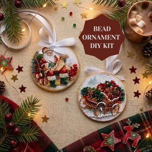 May include: Two round bead ornament DIY kits featuring a Santa Claus figure and a horse-drawn sleigh design. Each ornament is circular with a white ribbon bow at the top. The text BEAD ORNAMENT DIY KIT is printed in white on a dark red hexagon shape.