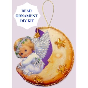 May include: A DIY bead ornament kit featuring a crescent moon with a sleeping face and a little angel with wings sitting on it. The moon is decorated with gold beads and stars. The angel is wearing a white dress and a floral crown. The kit includes all the beads and instructions needed to create the ornament.