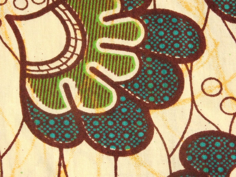 May include: A close-up of a fabric with a brown, green, and blue pattern. The pattern features a series of overlapping circles and leaves.